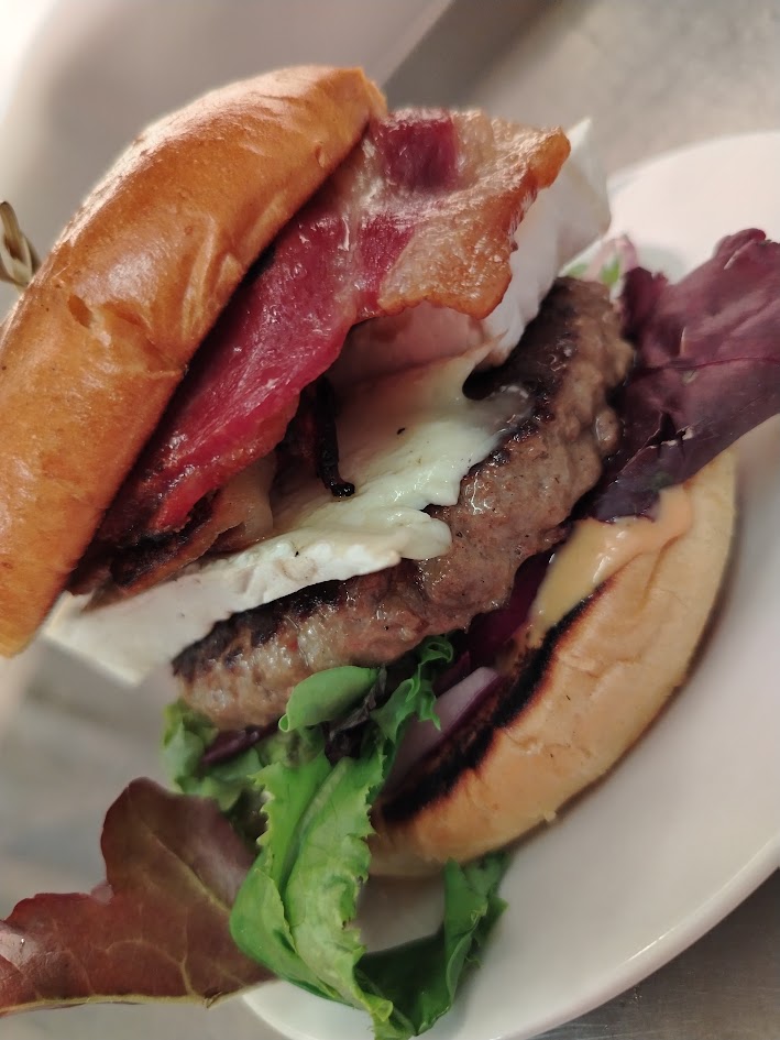 Bacon & brie burger in a brioche bun with salad